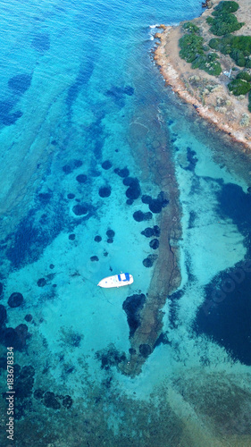 Aerial bird's eye view photo taken by drone of yacht docked and turquoise - sapphire clear waters