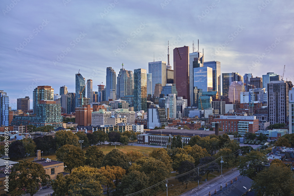 Toronto Skyline in autumn - Facades and rooftops of skyscrapers in the  Financial District of Toronto at sunset