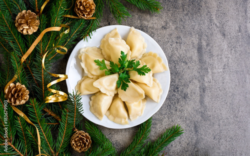 Christmas dumplings with decoration on a white plate. Top view.