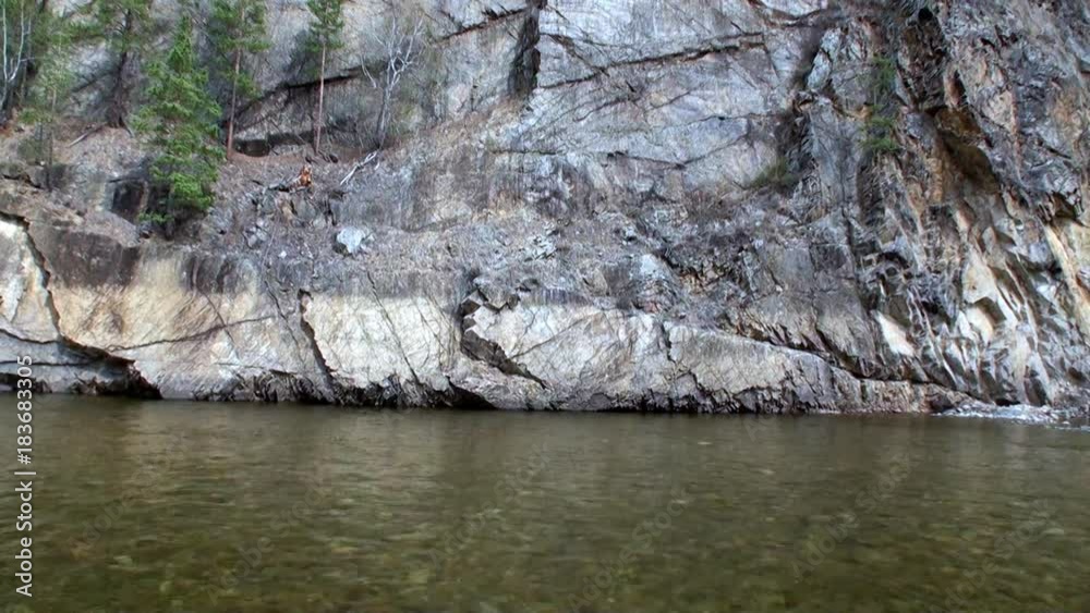 Rocky river bank in Mountain in Siberia of Russia. Border of Baikal State Nature Biosphere Reserve. Rocky river bank in Mountain in Siberia of Russia. Border of Baikal State Nature Biosphere Reserve.