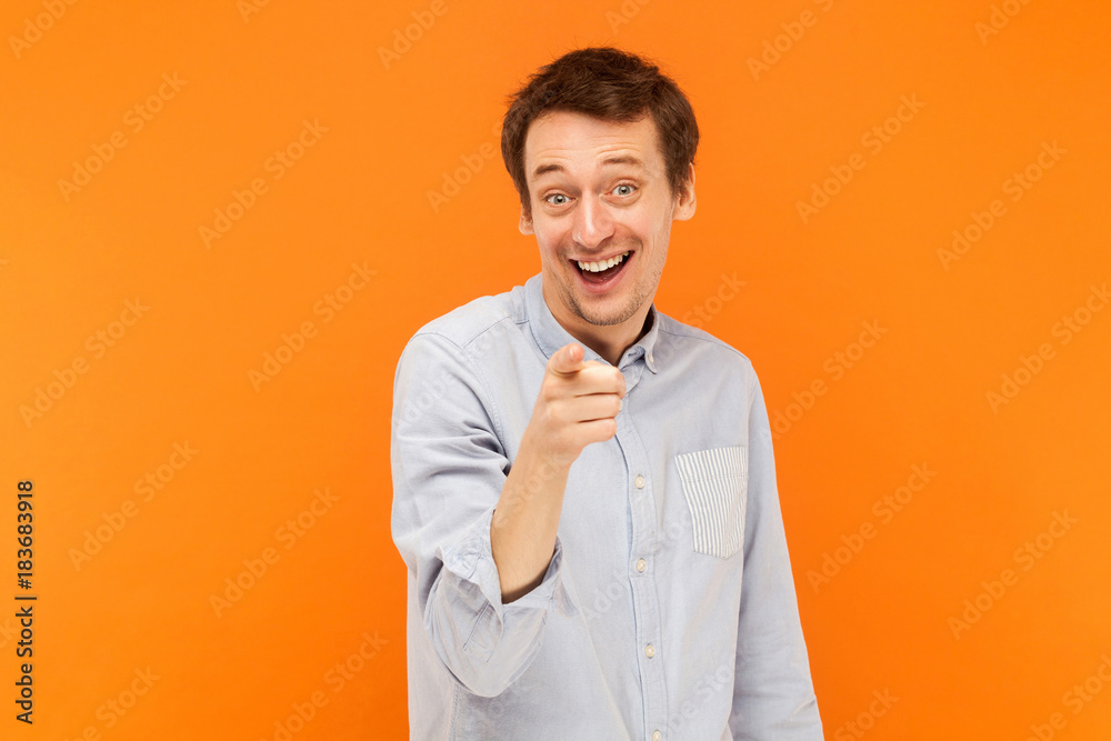 Hey you! Happiness man pointing finger at camera and toothy smile. Hey you! Happiness man pointing finger at camera and toothy smile.