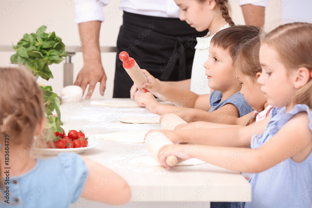 Cute children in kitchen during cooking classes Cute children in kitchen during cooking classes
