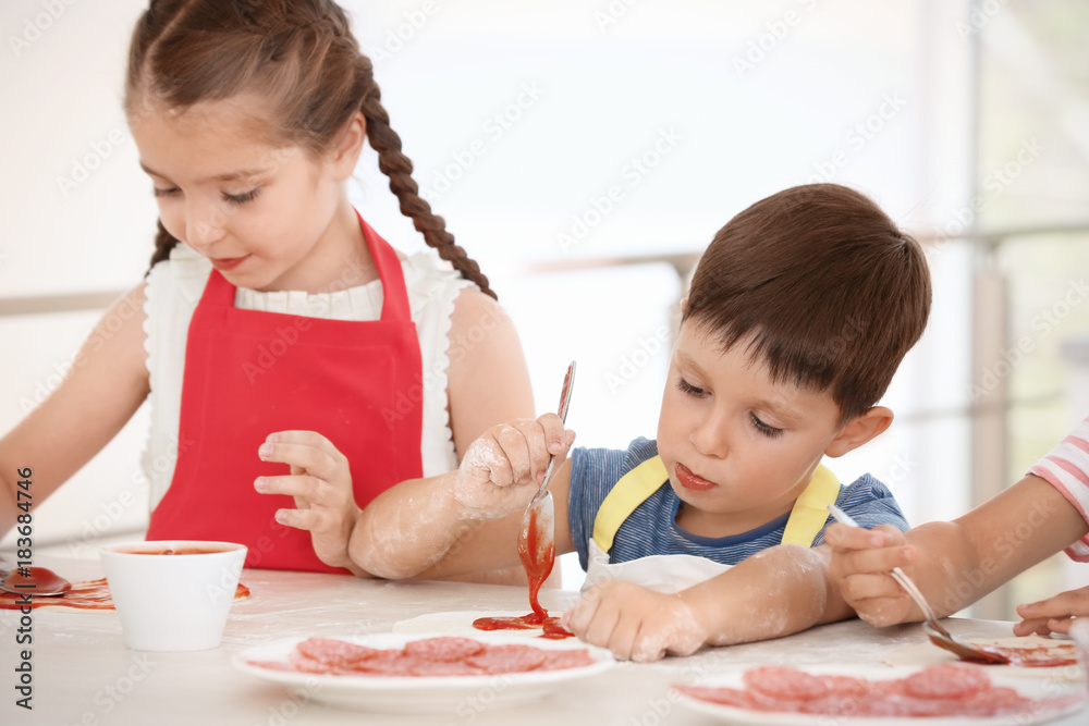 Cute children in kitchen during cooking classes