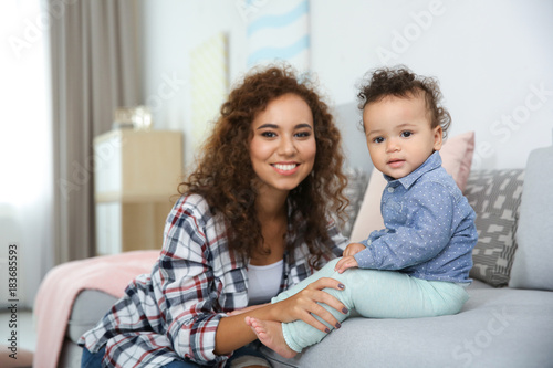 Cute baby and young mother ...