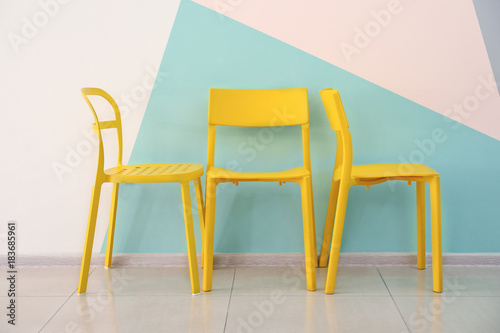 Comfortable chairs near color wall