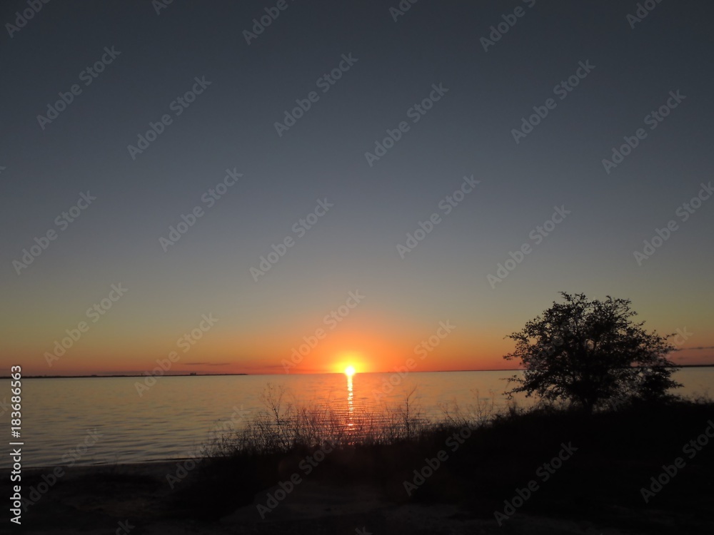 Sunset cutting through the bay