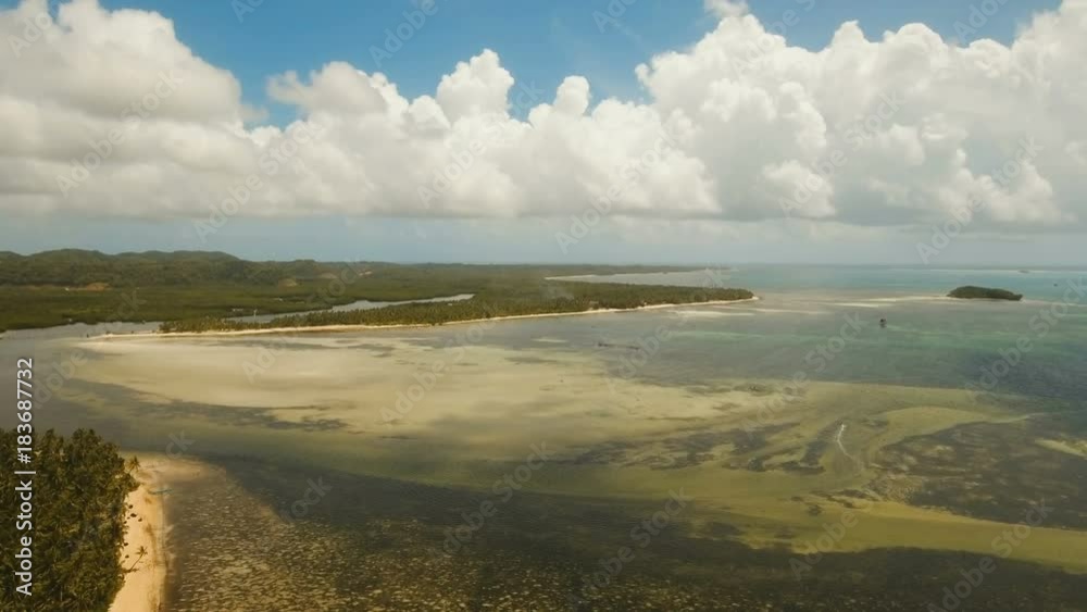 Aerial view of tropical beach on the island Siargao, Philippines. Beautiful tropical island with sand beach, palm trees. Tropical landscape: beach with palm trees. Seascape: Ocean, sky, sea Aerial view of tropical beach on the island Siargao, Philippines. Beautiful tropical island with sand beach, palm trees. Tropical landscape: beach with palm trees. Seascape: Ocean, sky, sea