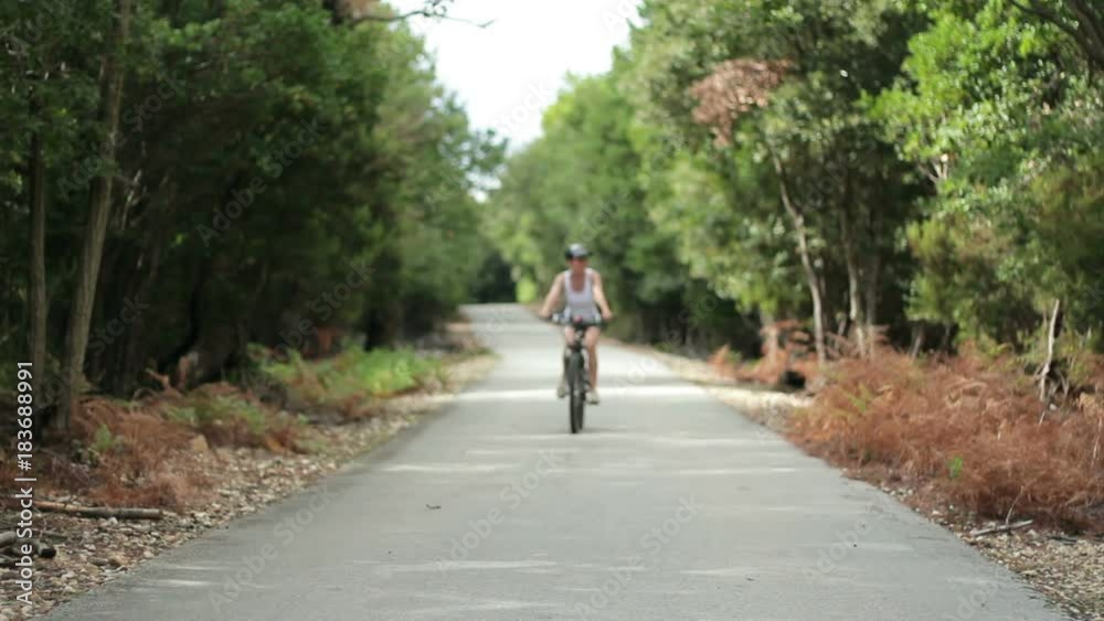 Young happy woman ride bicycle in the forest Young happy woman ride bicycle in the forest