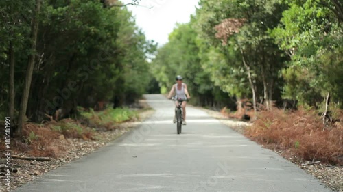 Wallpaper Mural Young happy woman ride bicycle in the forest  Torontodigital.ca