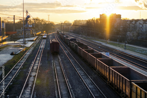railroad tracks with wagons at sunset