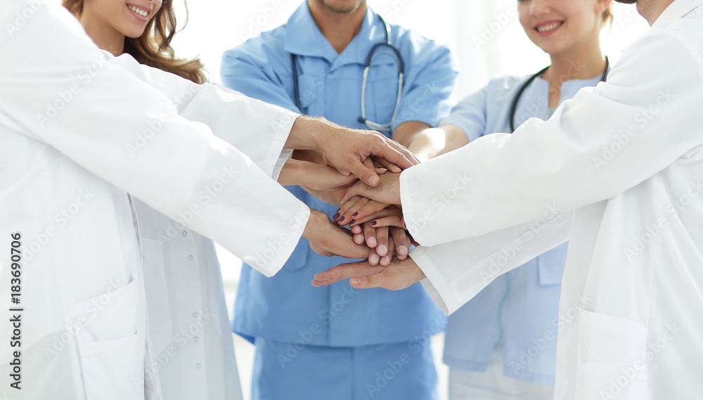 Doctors and nurses stacking hands. concept of mutual aid. Doctors and nurses stacking hands. concept of mutual aid.