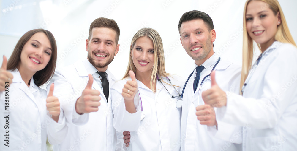 Portrait of a doctor and medical team showing thumb up Portrait of a doctor and medical team showing thumb up