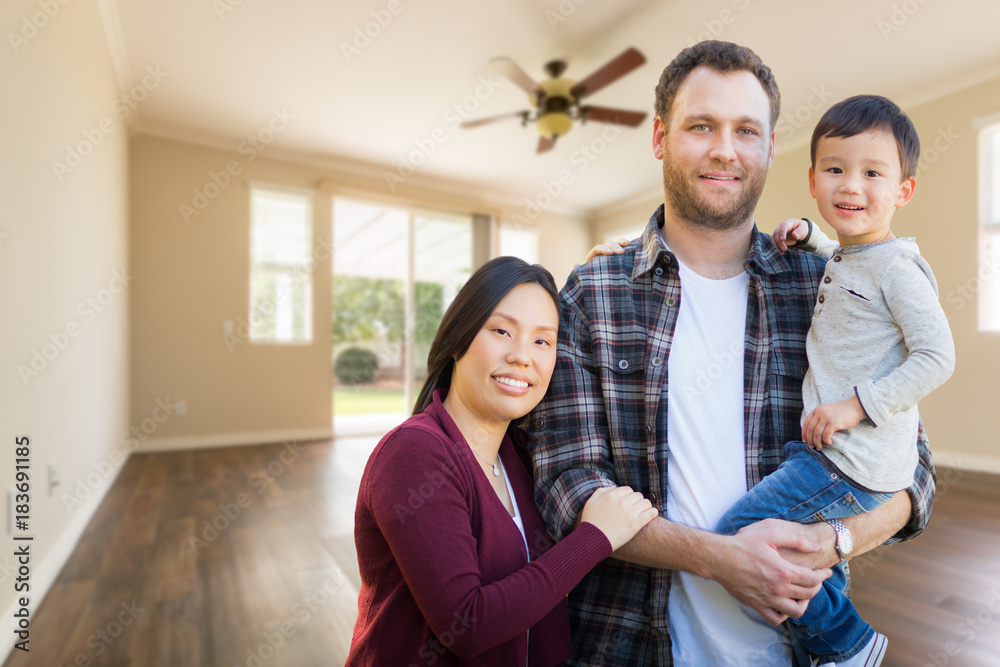 Mixed Race Chinese and Caucasian Parents and Child Inside Empty Room of New House. Mixed Race Chinese and Caucasian Parents and Child Inside Empty Room of New House.