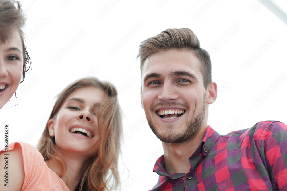 closeup of three young people smiling on white background closeup of three young people smiling on white background