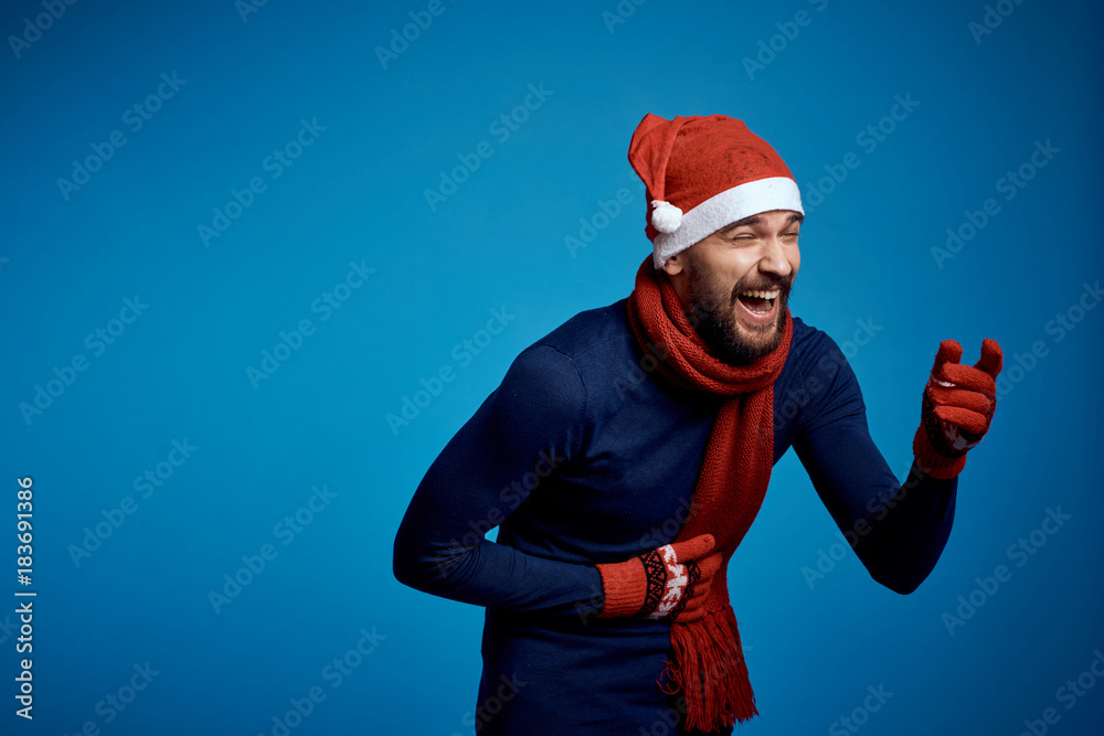 man holds his hand to his stomach and laughs, blue background, free space to copy, new year man holds his hand to his stomach and laughs, blue background, free space to copy, new year