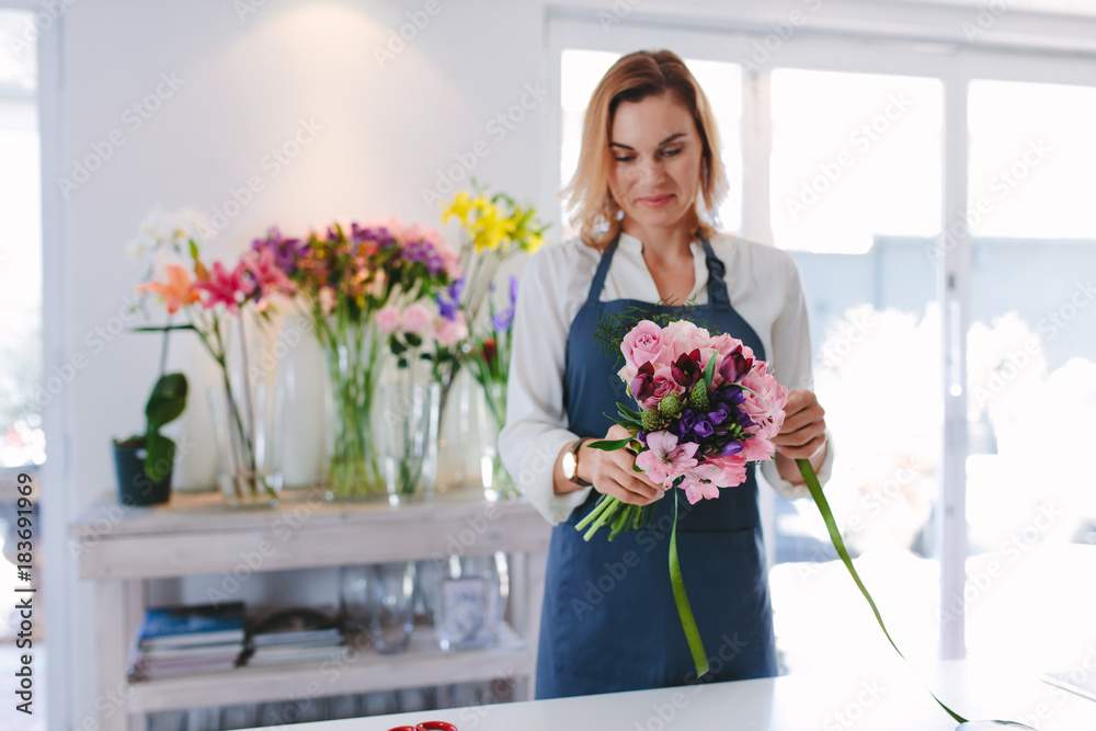 Female florist preparing a bouquet