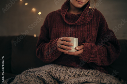 Woman having coffee in winter at home photo