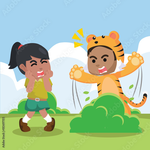 A boy wearing a tiger costume for surprising a girl