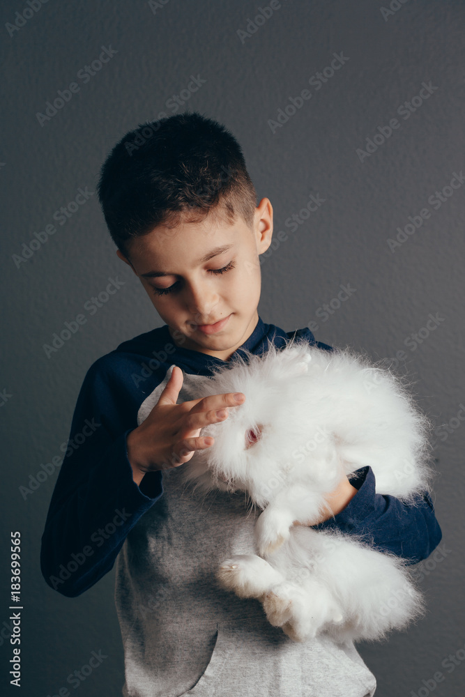 Happy smiling little boy with a rabbit Happy smiling little boy with a rabbit