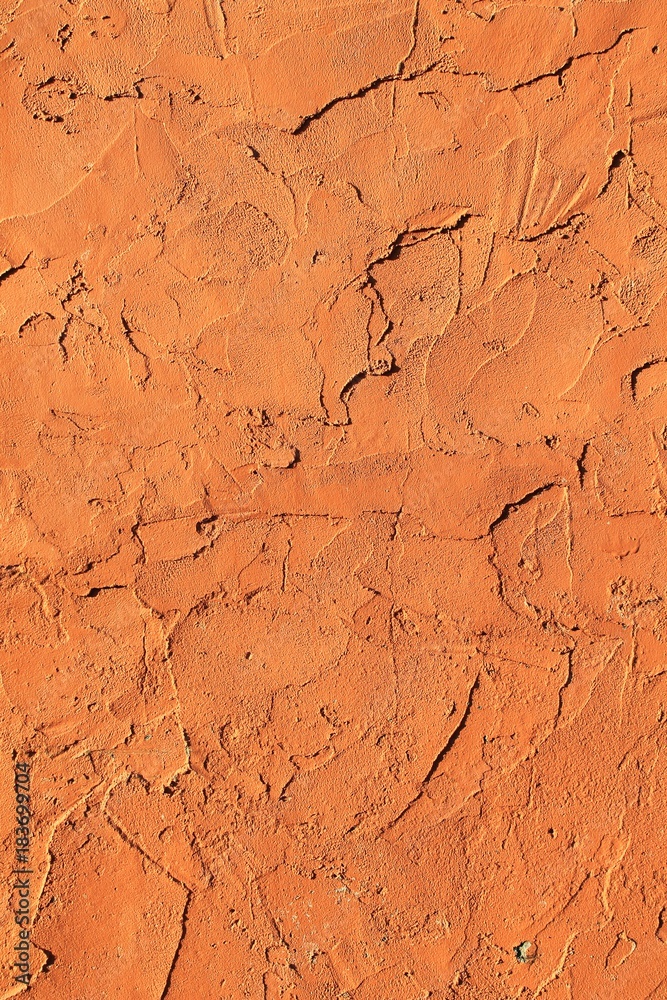 Fototapeta premium Vertical orange adobe clay rough background texture