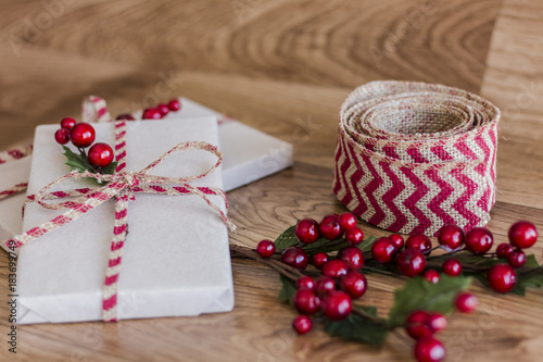 Fototapeta Naklejka Na Ścianę i Meble -  Wrapped Christmas presents on a wood background
