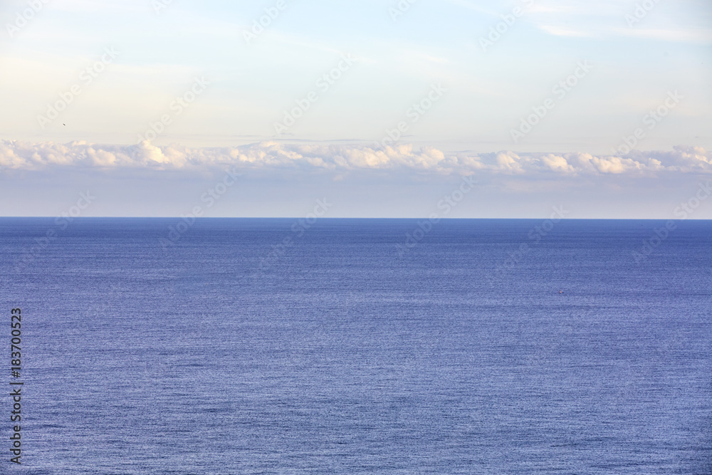 Blue sea on sky background. Beautiful blue sea against the blue sky. Mediterranean Sea.