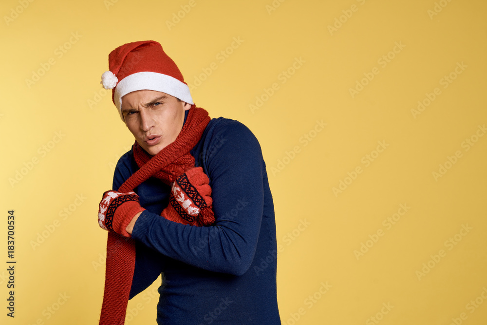 man with scarf freezes, yellow background, free space for copy, new year