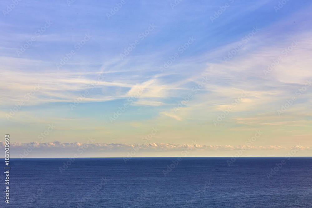 Blue sea on sky background. Beautiful blue sea against the blue sky. Mediterranean Sea. Sea and sunset.