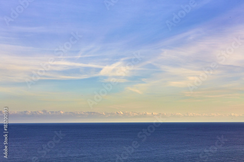 Fototapeta Naklejka Na Ścianę i Meble -  Blue sea on sky background. Beautiful blue sea against the blue sky. Mediterranean Sea. Sea and sunset.