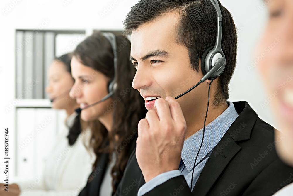 Smiling cheerful male telemarketing customer service agent, call center job concept Smiling cheerful male telemarketing customer service agent, call center job concept