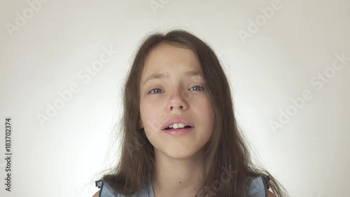 Beautiful sad teenage girl emotionally expresses pain and resentment close-up on white background stock footage video