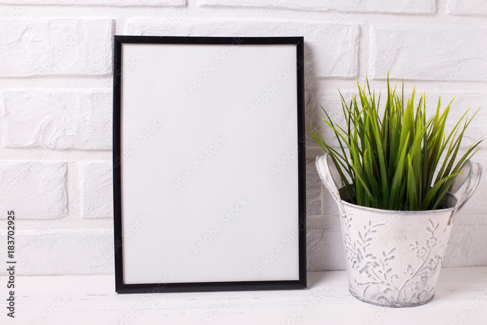 Fototapeta premium Empty frame mockup with copy space and grass in pot