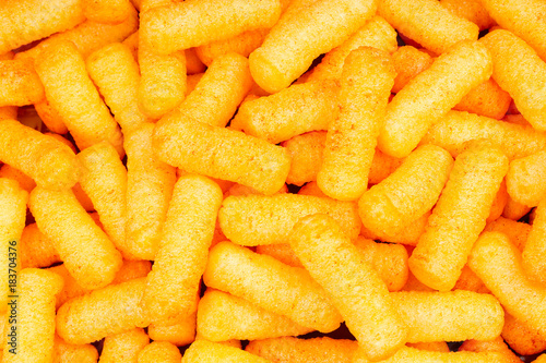 Cheese puff. Cheese puffs snack background texture food pattern. Snacks.