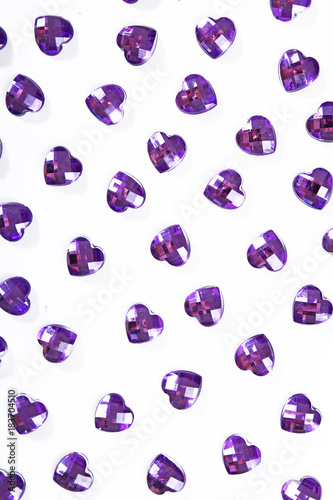 Purple rhinestone background. Heart shape texture as backdrop isolated white studio photo. Bling rhinestone crystal pattern. Rhinestones crystals as background.