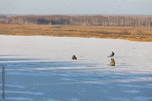 The fishermans is fishing on the ice