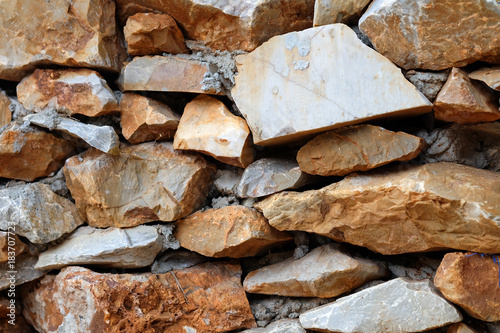 Real stone wall stacked layers are uneven texture background