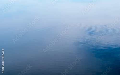 Reflection of blue sky with cloud on water,abstract background.