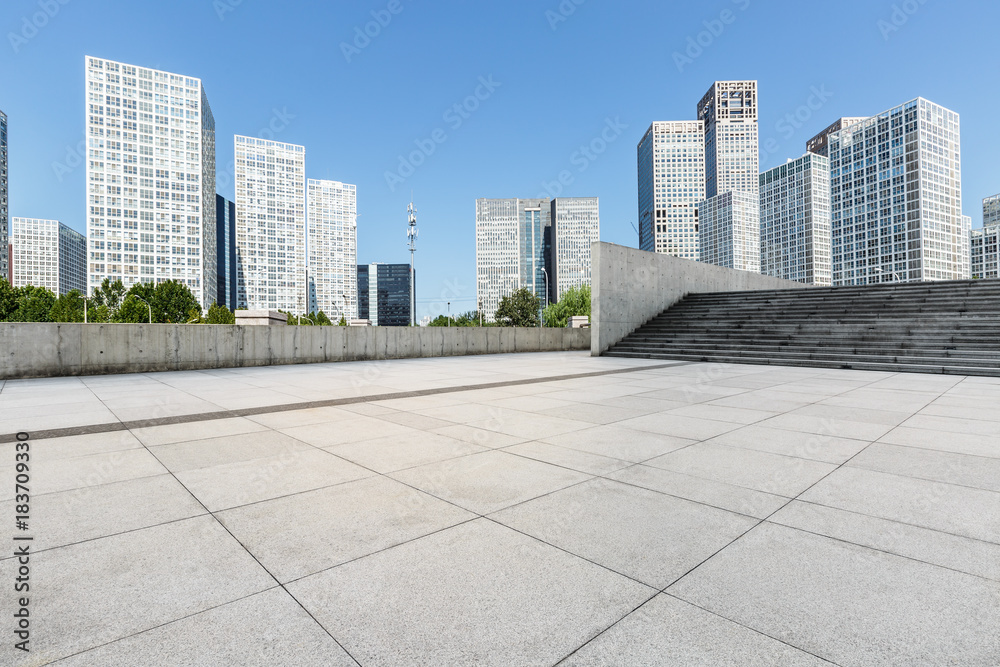 Empty city square floor and modern city commercial buildings scenery