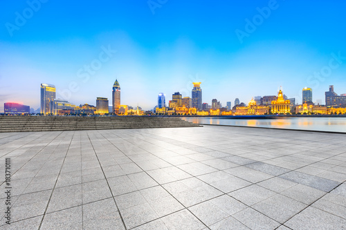 Empty square floor and with cityscape and skyline at sunset in Shanghai,China