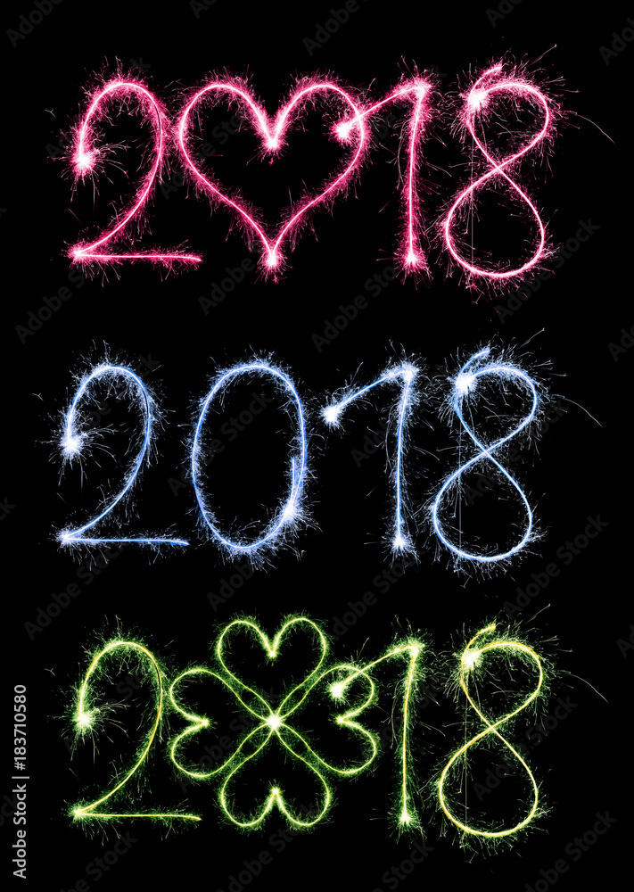 2018 writen with sparklers on black background, concept of New Year.