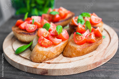 Traditional Italian bruschetta with tomatoes and spinach