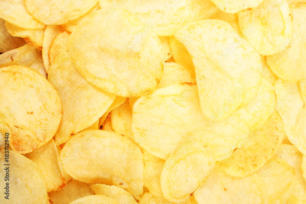 Chips pattern. Yellow salted potato chips as background. Chips texture studio photo Food photo.