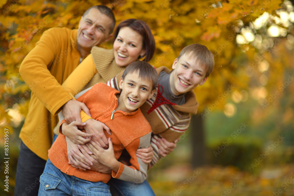 Fototapeta premium smiling family in autumn forest 