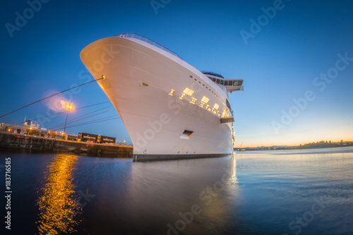 large cruise ship moored at pier at sunset