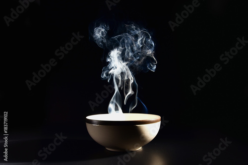 Picture of smoke rising from the food above the cup The concept of hot food.