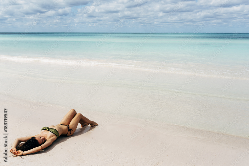 Young woman relax on the beach. Young woman relax on the beach.