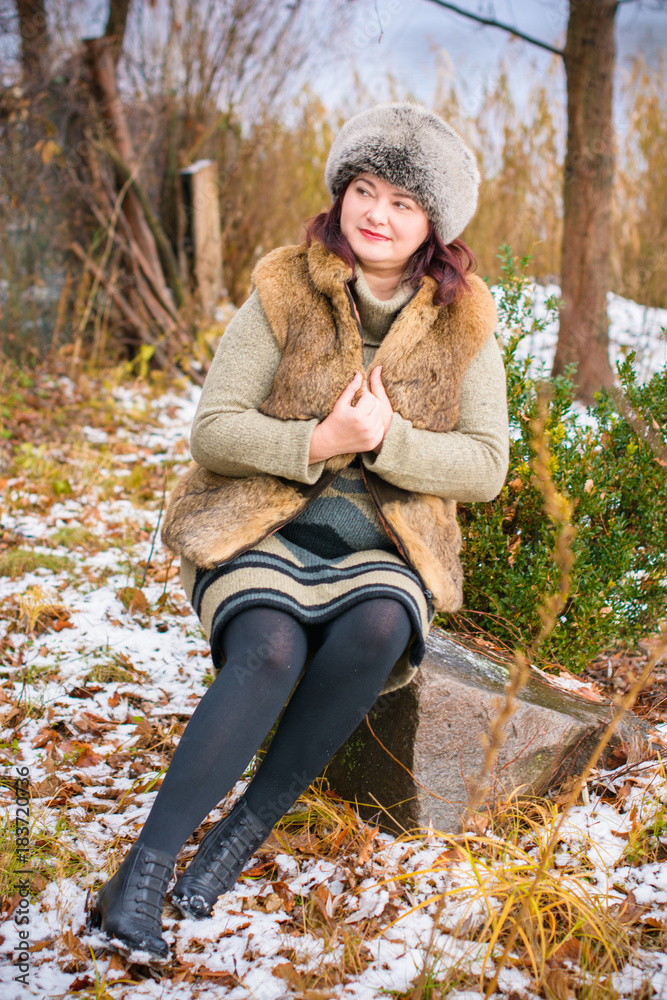 Simple middle age plus size woman wear in knitted dress and fur