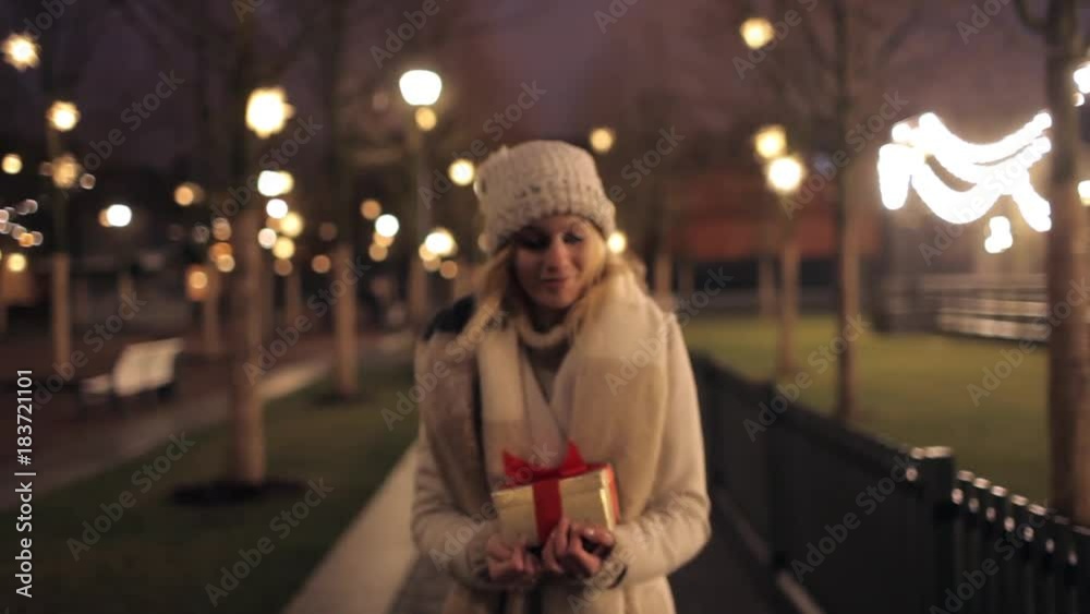 beautiful girl with a gift box in the park beautiful girl with a gift box in the park