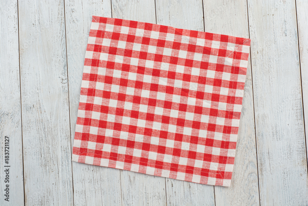Red tablecloth on white wooden table background. Red tablecloth on white wooden table background.