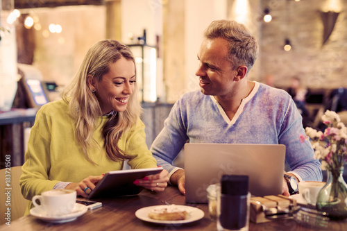 Woman and man working in cafe